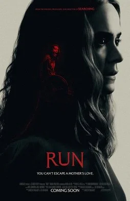 Dark movie poster featuring a woman's face in profile, with a small red figure of a girl sitting on top of a circular object. The title 'RUN' appears in large red letters, with the tagline 'You can't escape a mother's love' below. The poster has a predominantly black background.
