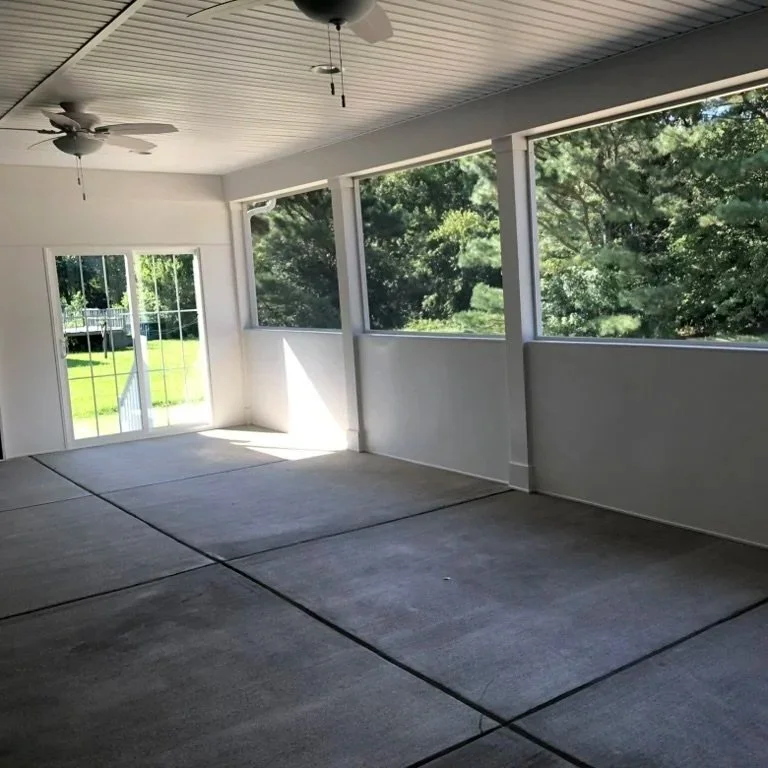 Enclosed screened porch with a half privacy wall in Selbyville, Delaware.