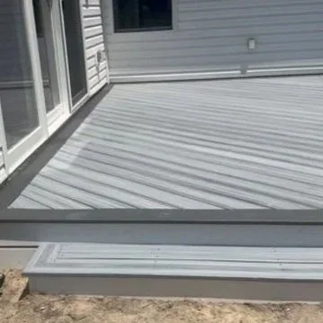 Ground-level deck with Trex decking and border in Millsboro, Delaware.