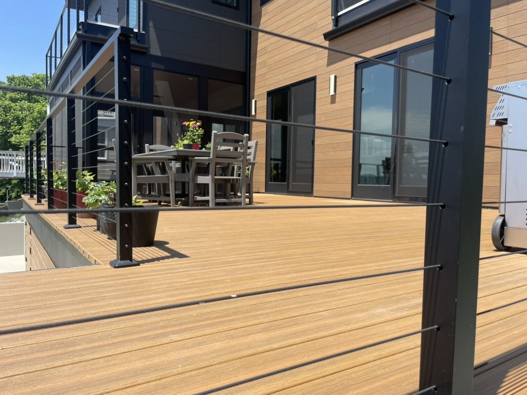 DuxxBak decking board in Cedar color with Black Metal Posts and Stainless Steel Cable Railing