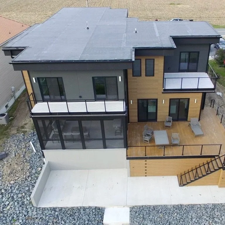 DuxxBak decking board in Cedar color with Black Metal Posts and Stainless Steel Cable Railing