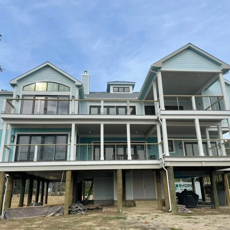 Multi-story deck built on stilts. Cable railing and custom posts in Rehoboth Beach, Delaware.