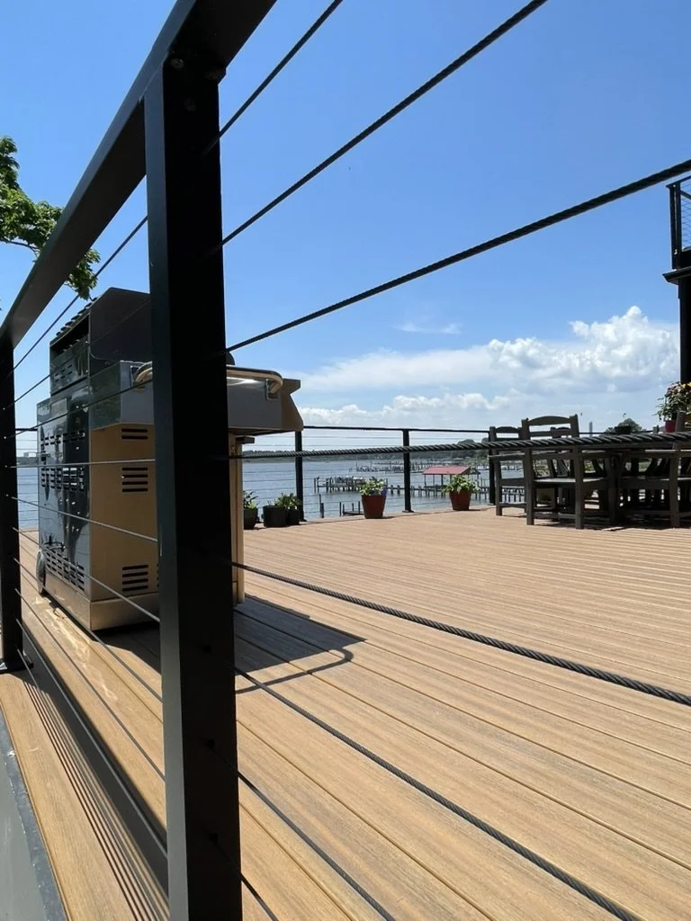 DuxxBak decking board in Cedar color with Black Metal Posts and Stainless Steel Cable Railing