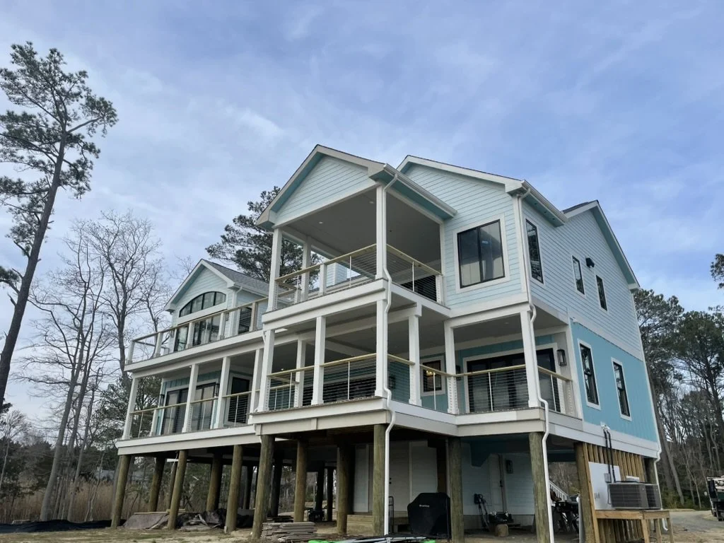 Multi-story deck built on stilts. Cable railing and custom posts.