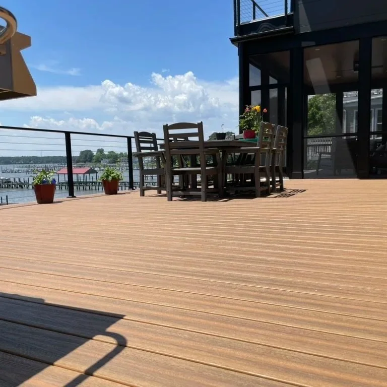DuxxBak decking board in Cedar color with Black Metal Posts and Stainless Steel Cable Railing