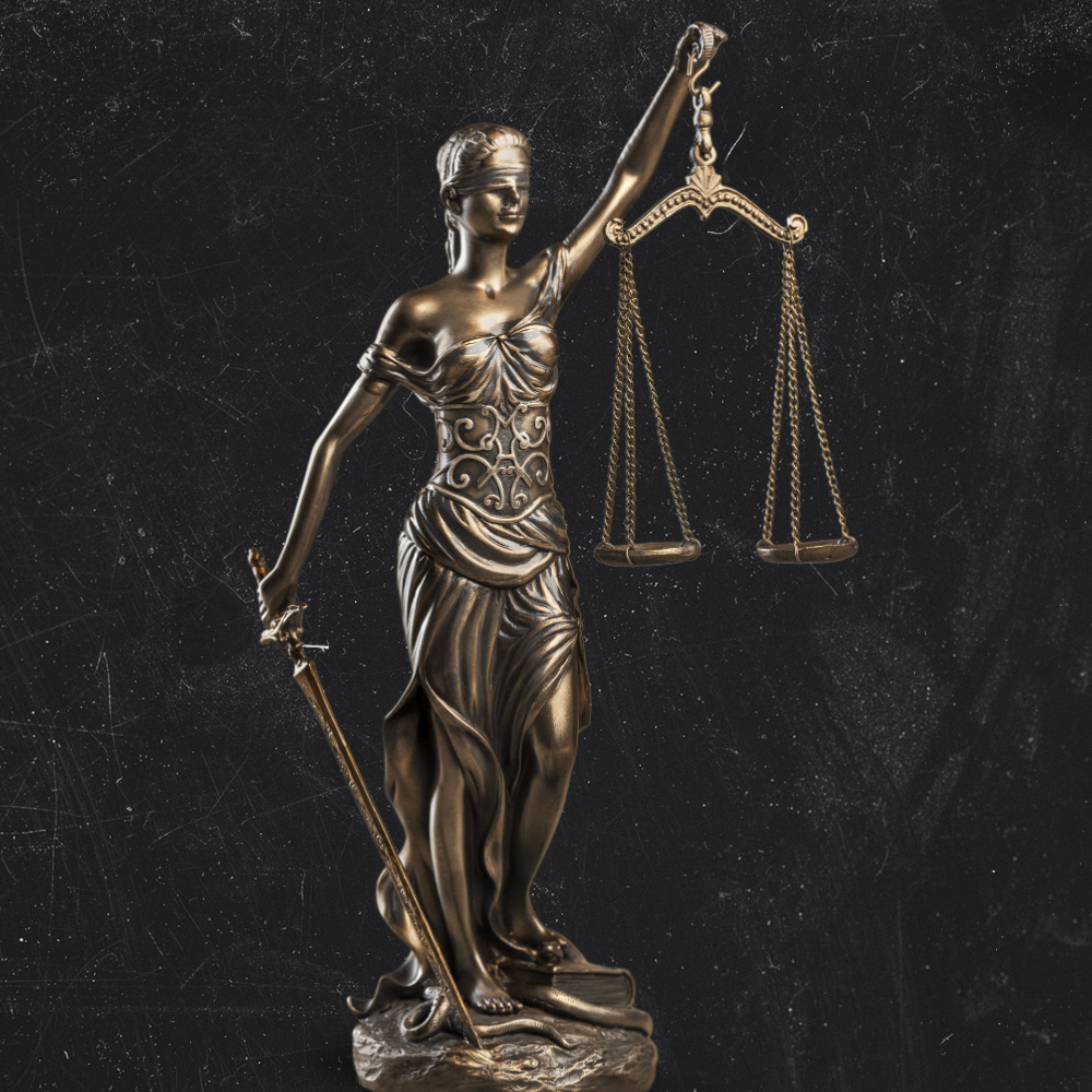 A bronze statue of Lady Justice holding a sword in her right hand and balancing scales in her left hand, with her eyes blindfolded, against a black textured background.