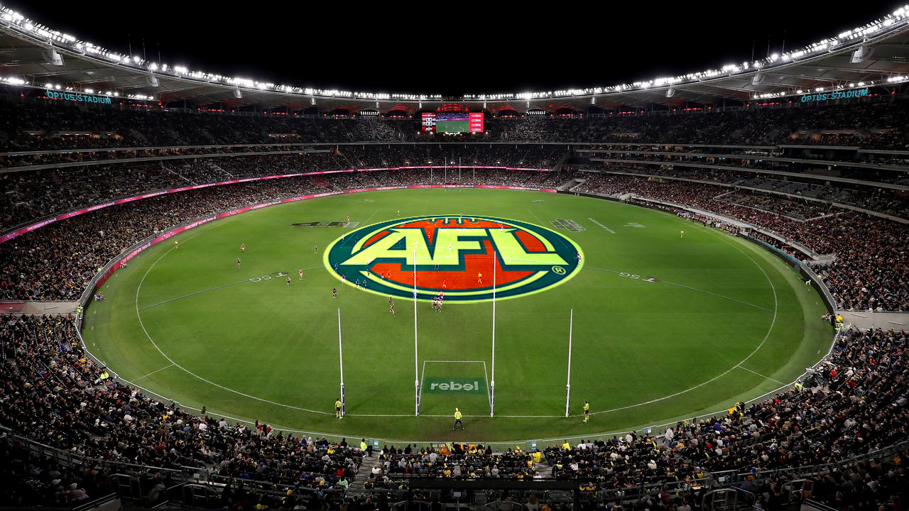 Interior view of Optus Stadium during an Australian Football League game, with the AFL logo on the field and spectators in the stands.