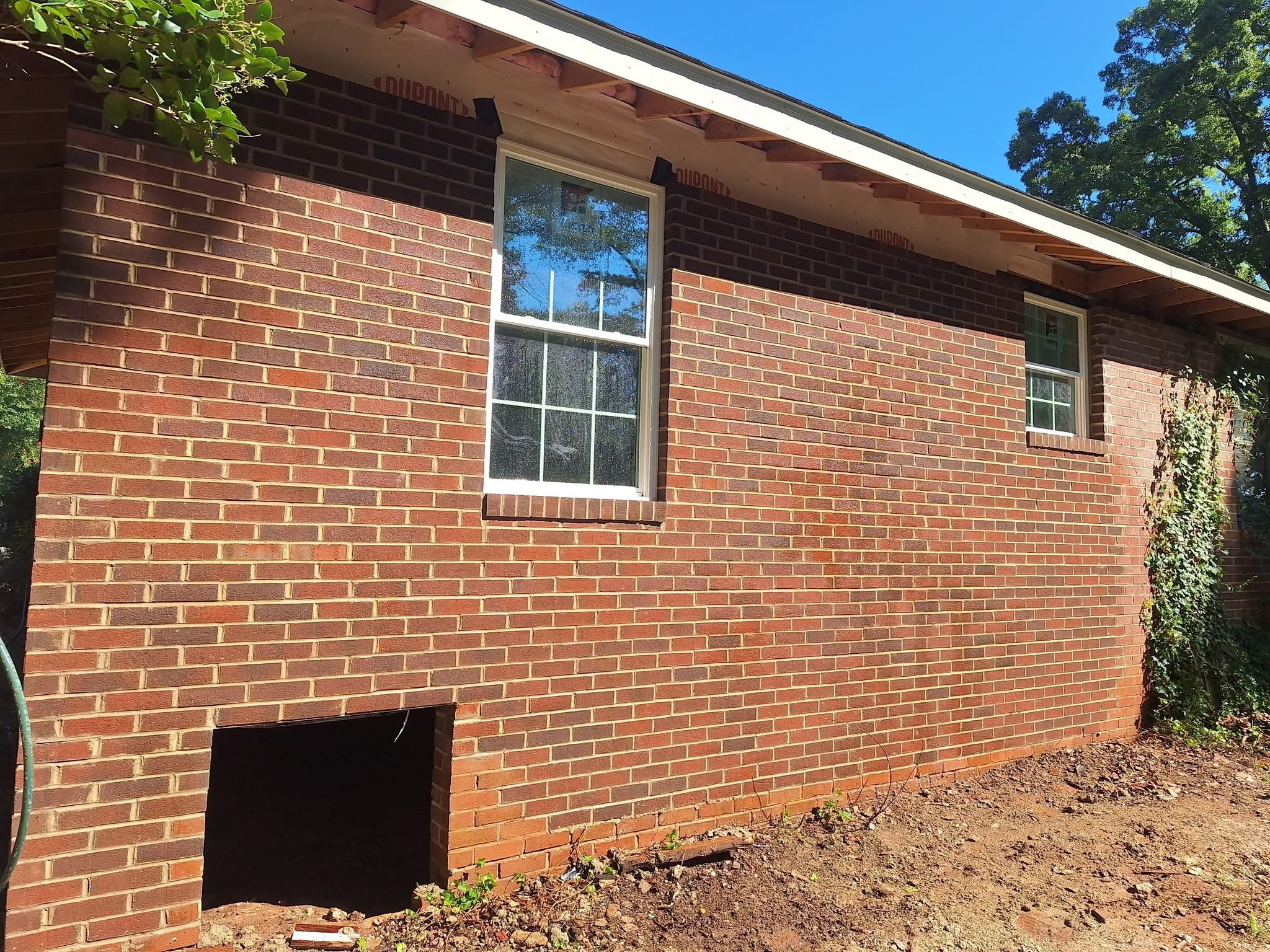 Oranssi technician working on a roof project