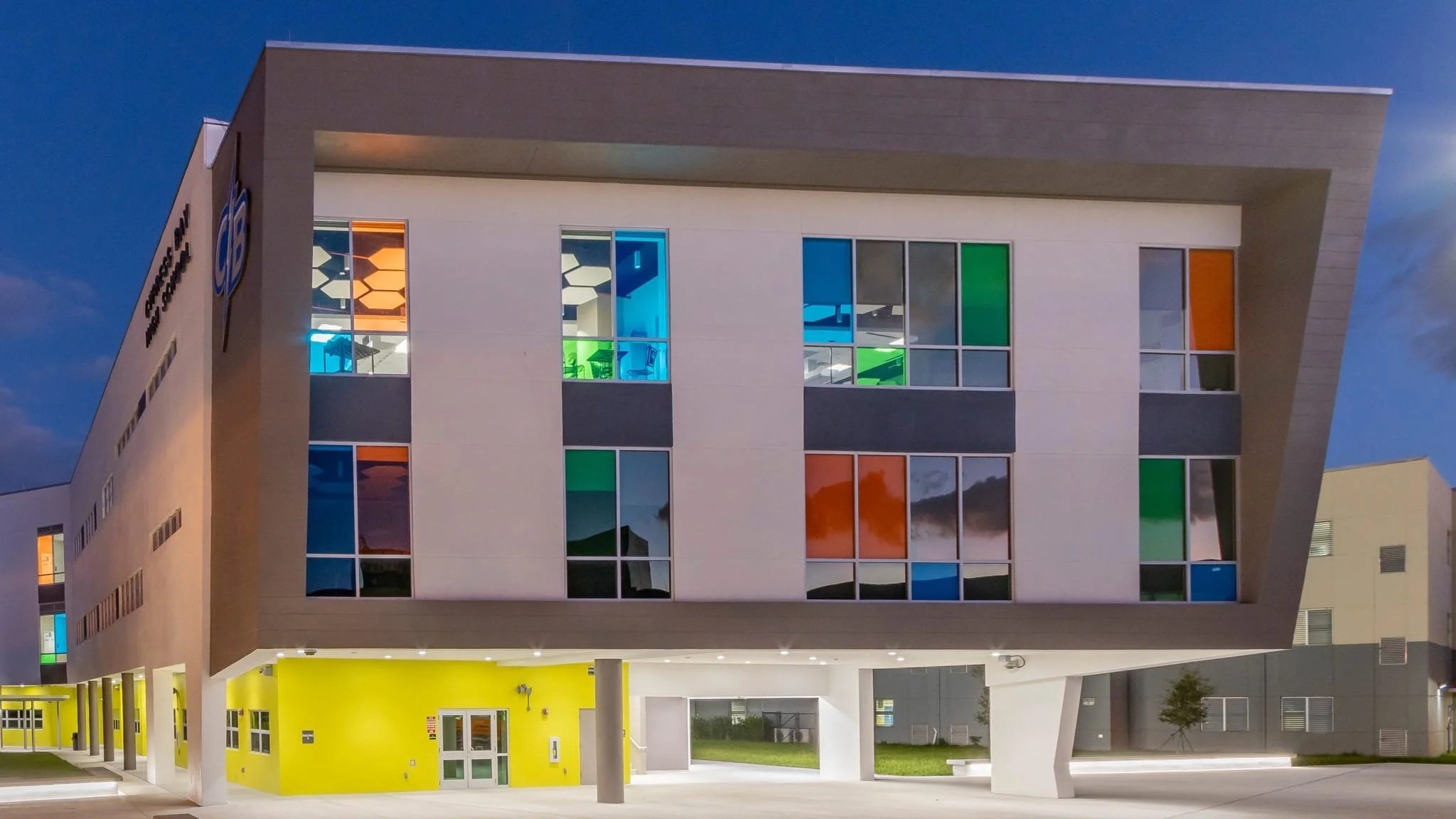 Cypress Bay High School building exterior at dusk. Project experience completed by our leadership team while serving in construction management roles.