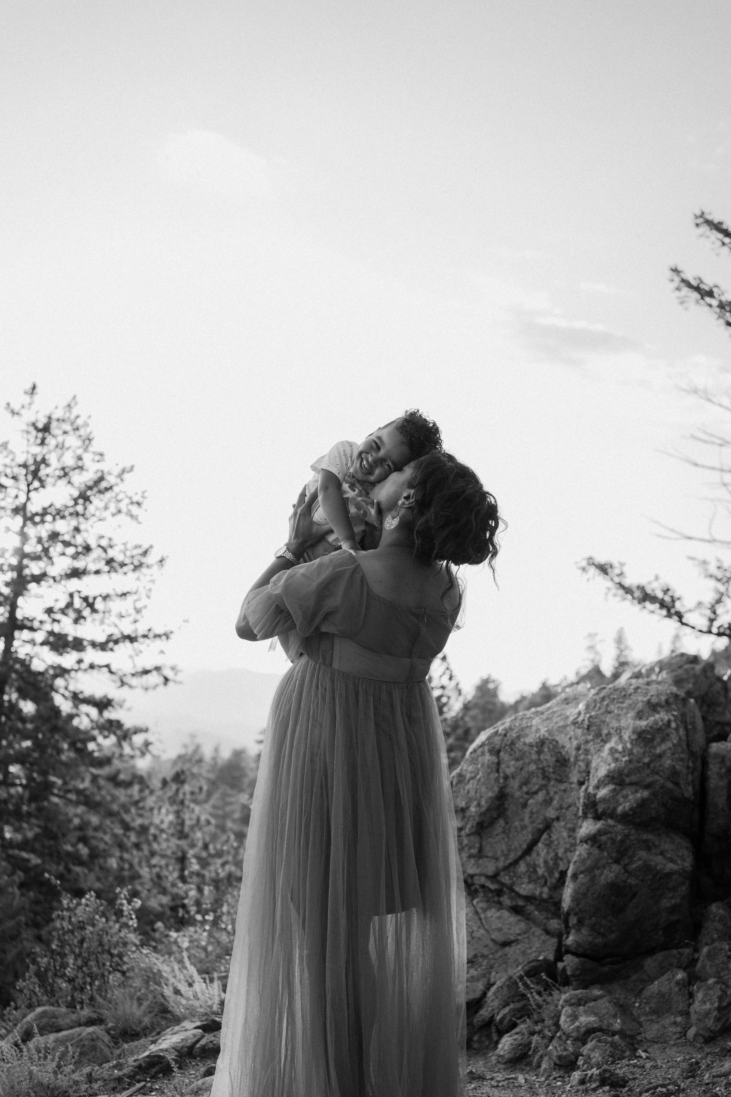 Mother holding her child during a lifestyle family photography session outdoors.