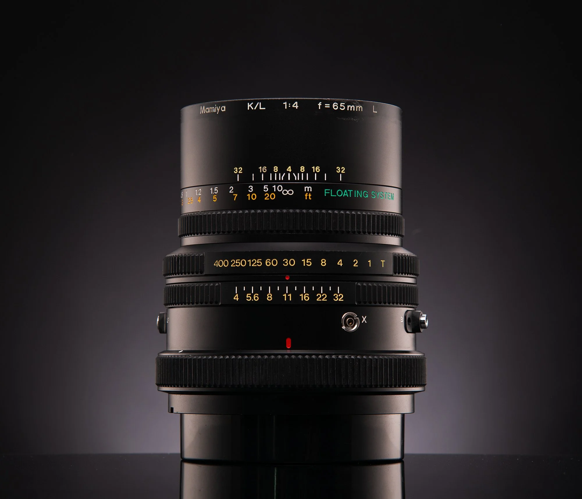 A professional camera lens against a dark background.