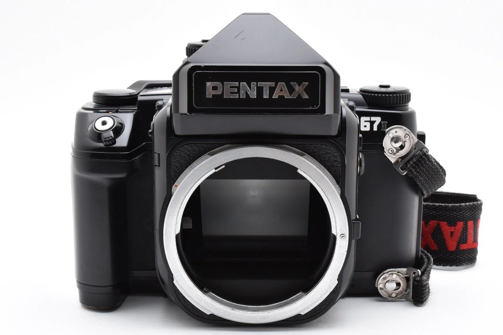 A black Pentax film camera body with no lens attached, displaying the front view, isolated on a white background.