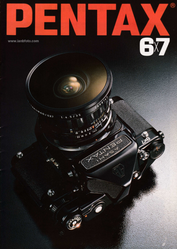 A Pentax camera with a 6x7 film format is shown on the cover of a photography magazine. The camera has a large lens and a textured grip, placed on a black surface with a subtle reflection.