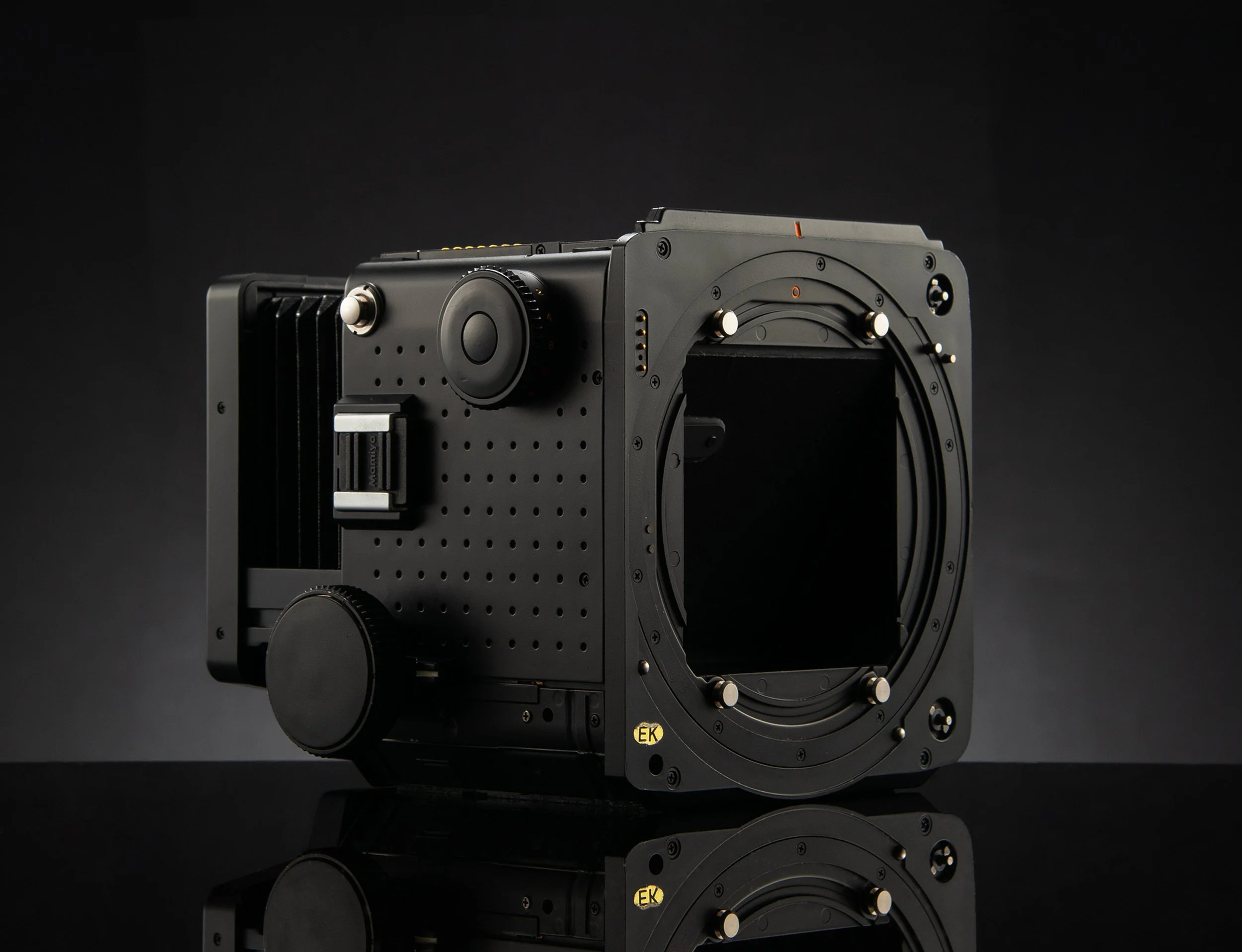 Mamiya RZ67 Pro body with electronic controls and mounting plate on a black background.