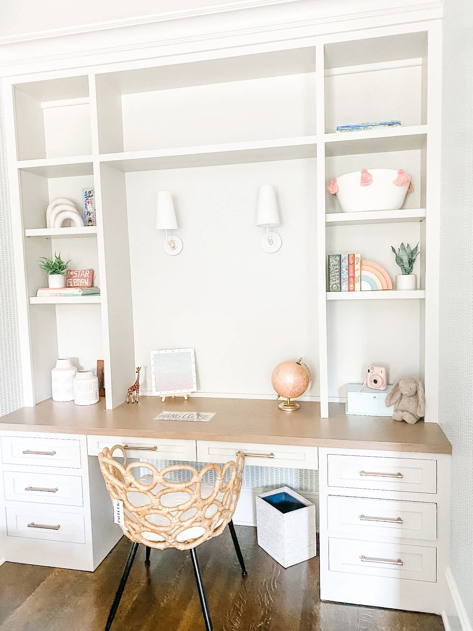 A clean built-in desk with a woven chair creates a tidy, functional workspace for an organized home.