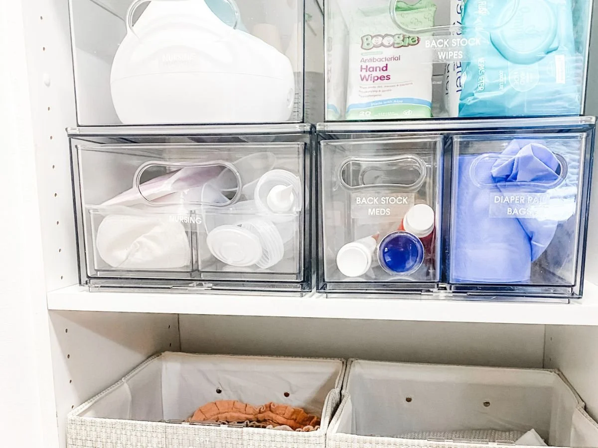 Organized nursery storage shows how to unpack and organize after moving with labeled bins for baby essentials.