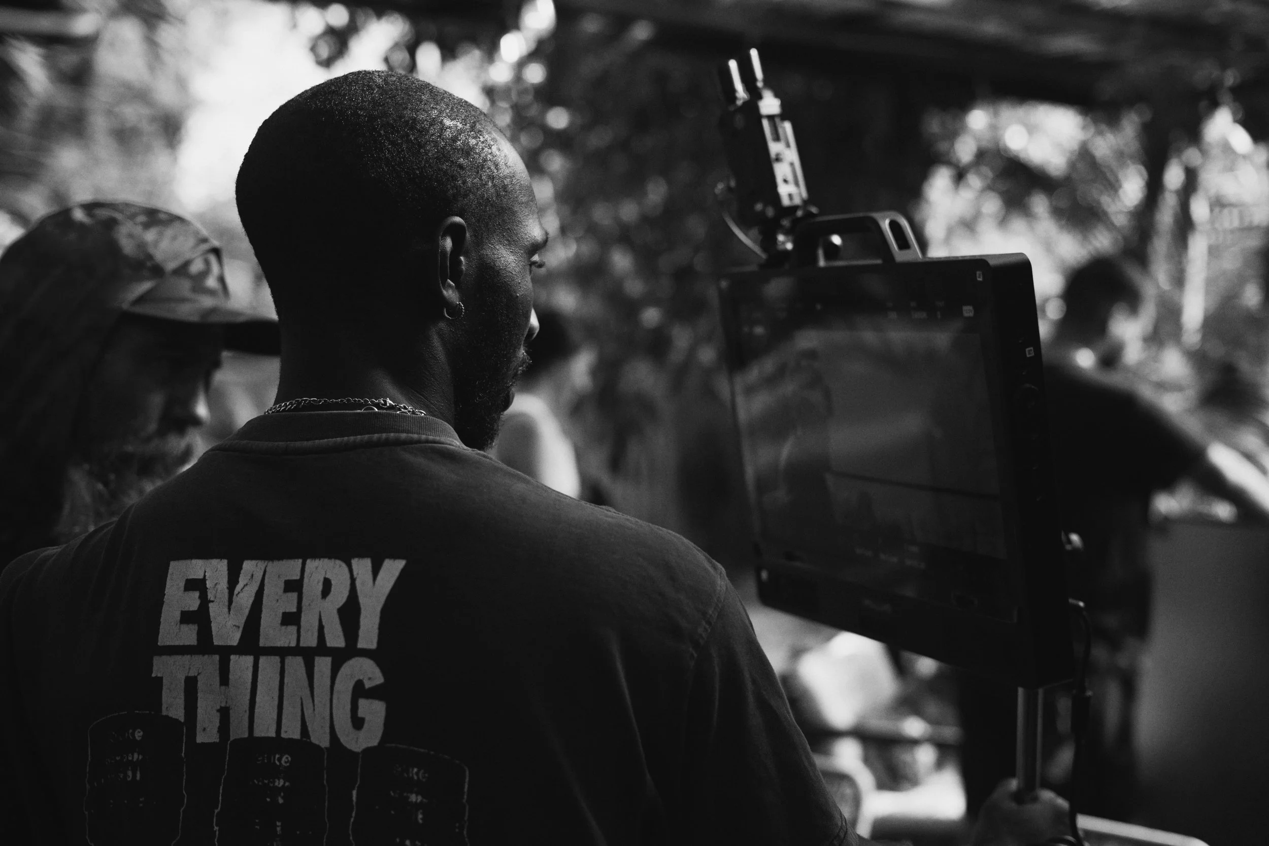 Cinematic frame from a Cisco commercial directed by ST Davis — silhouetted figures backlit in a dark interior