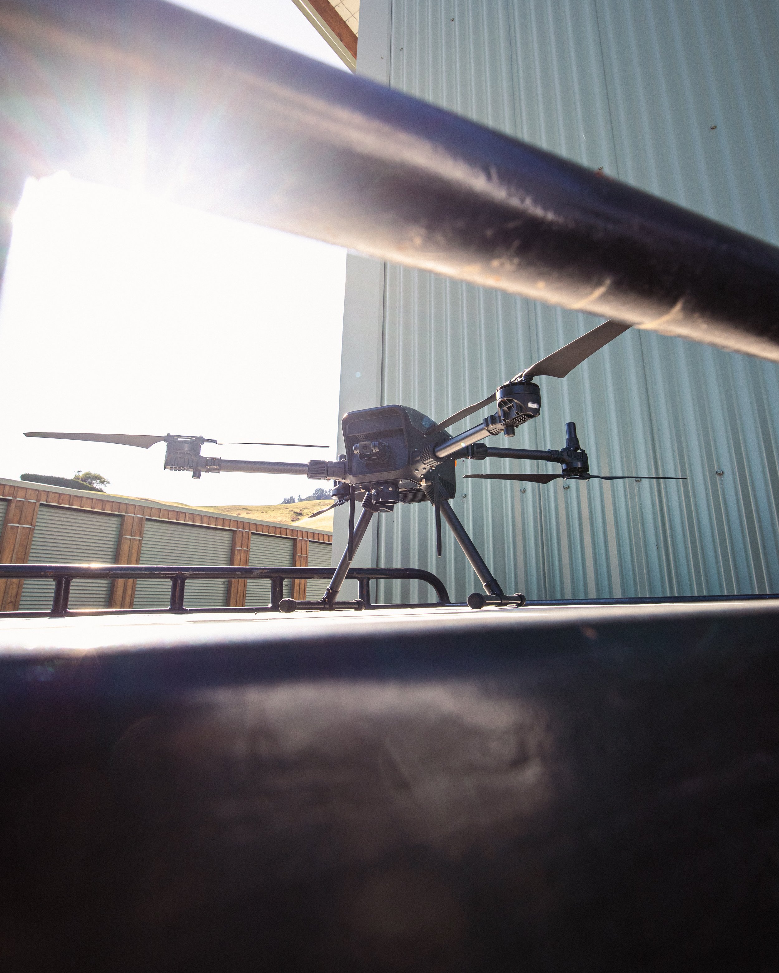 Image of drone sitting on tray of a ute