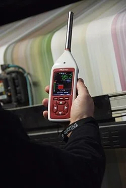 Person holding a sound meter