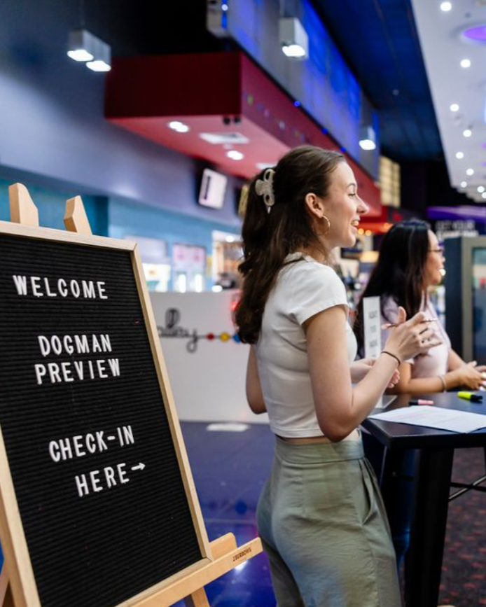 Abbie Sykes, working the check-in desk at a large-scale Brisbane film premiere with over 250 guests.
