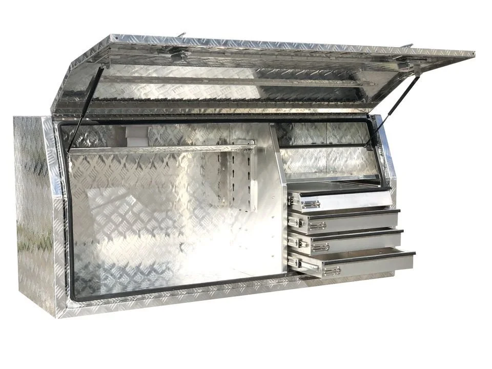 A silver, metal storage box with a hinged lid and multiple smaller drawers on one side.