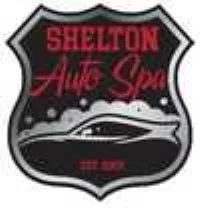 A logo for Shelby Amie Spa featuring a black shield shape, red text, and an illustration of a car with bubbles.