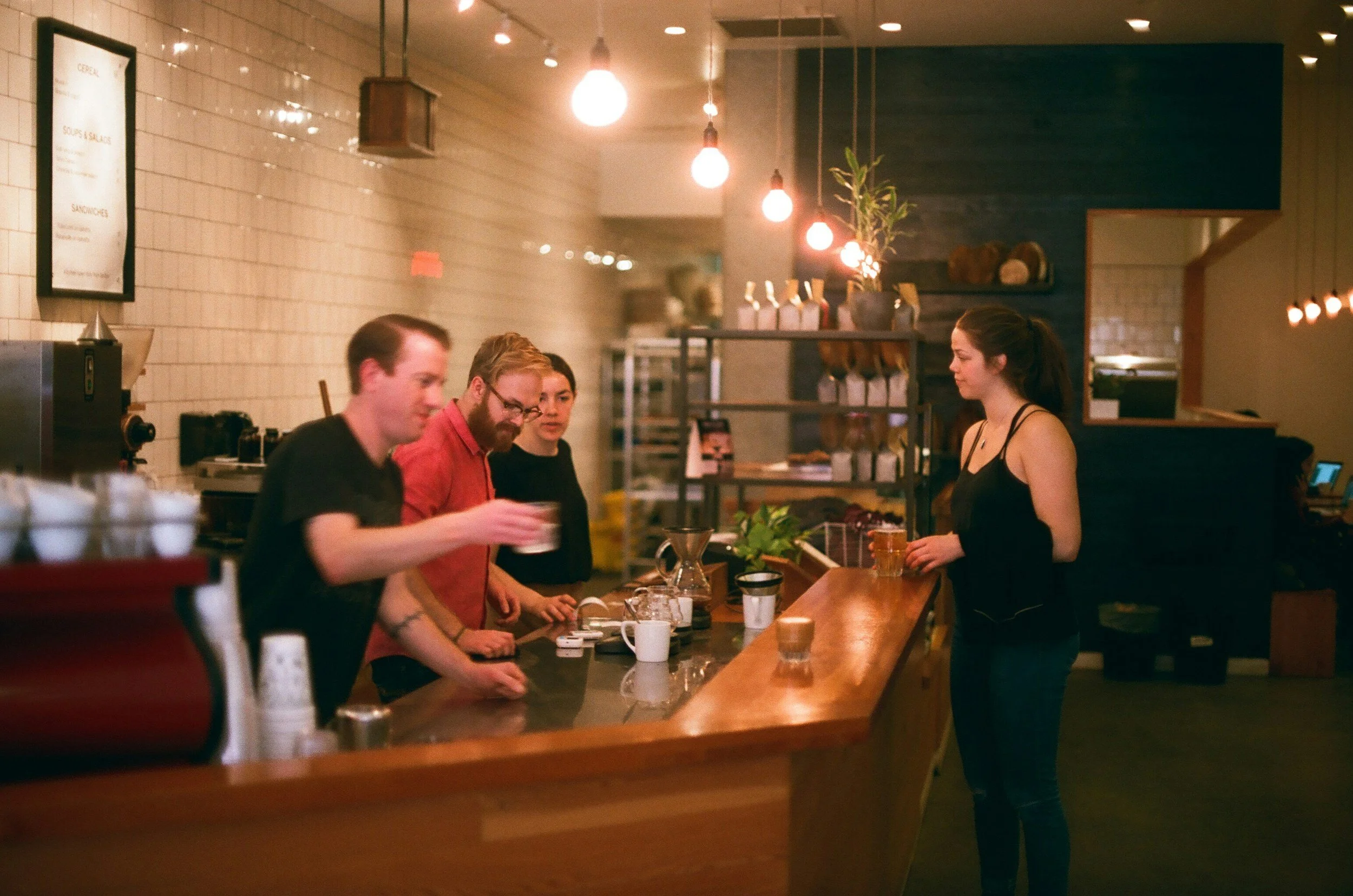 Staff serving at the counter of an upscale pub