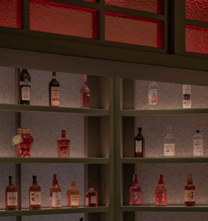 Shelves with various bottles of liquor and spirits, some with labels and others with decorative designs.