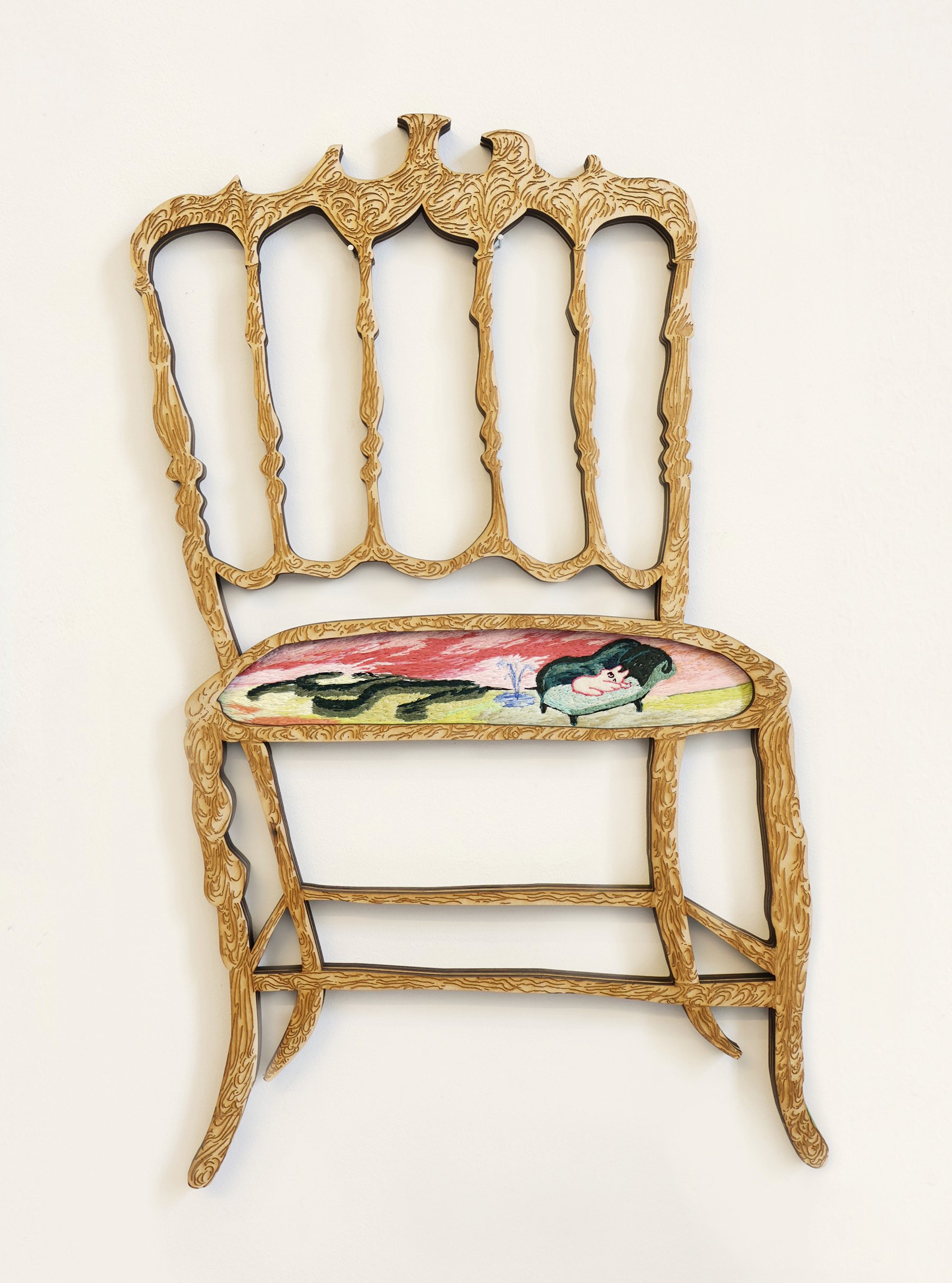 Decorative wooden chair with an intricately carved backrest and a colorful fabric seat featuring a cartoon-style image of a dog lying down.