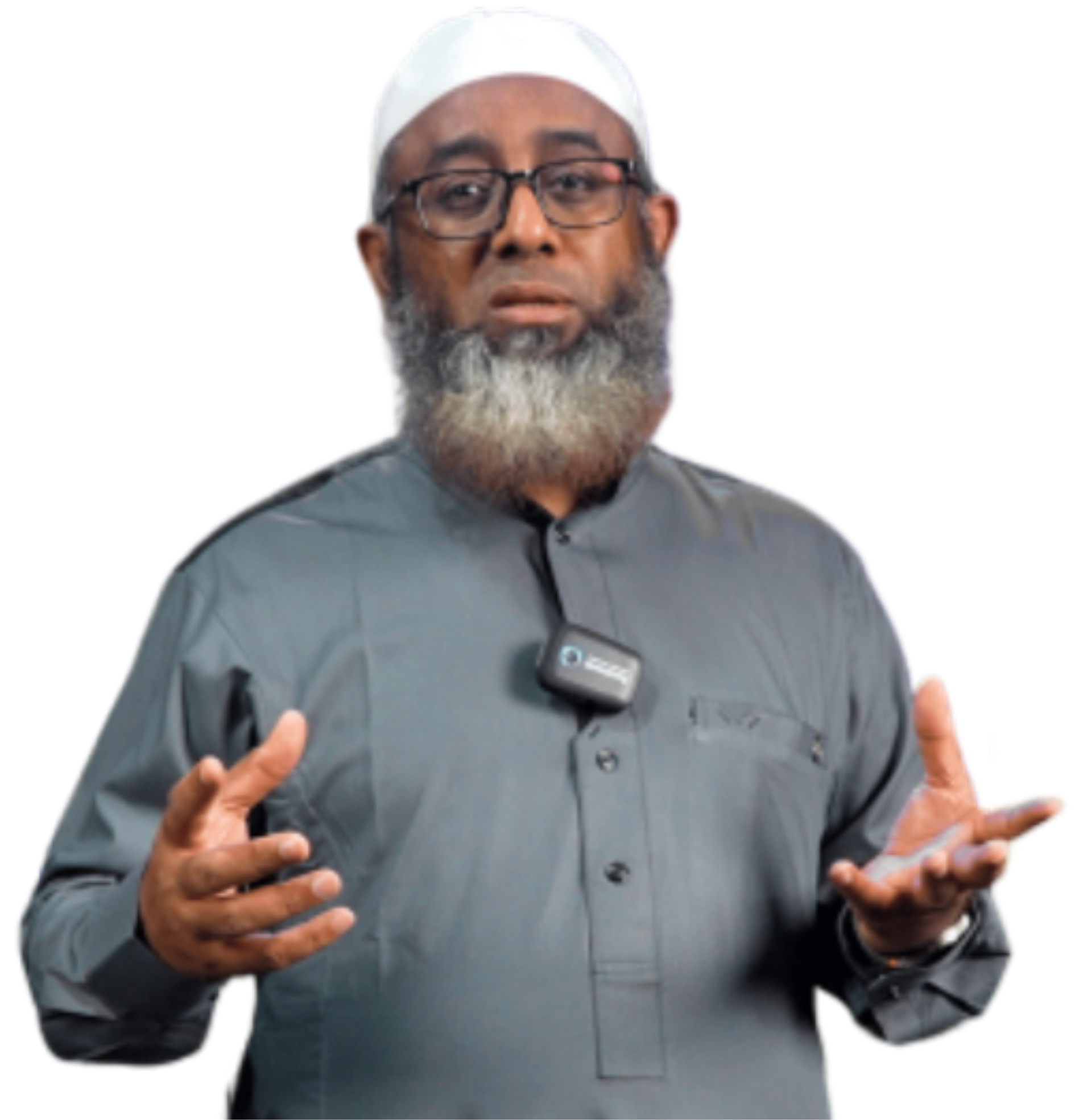 Man with beard, glasses, and white cap wearing a gray shirt, gesturing with hands, speaking during a presentation.