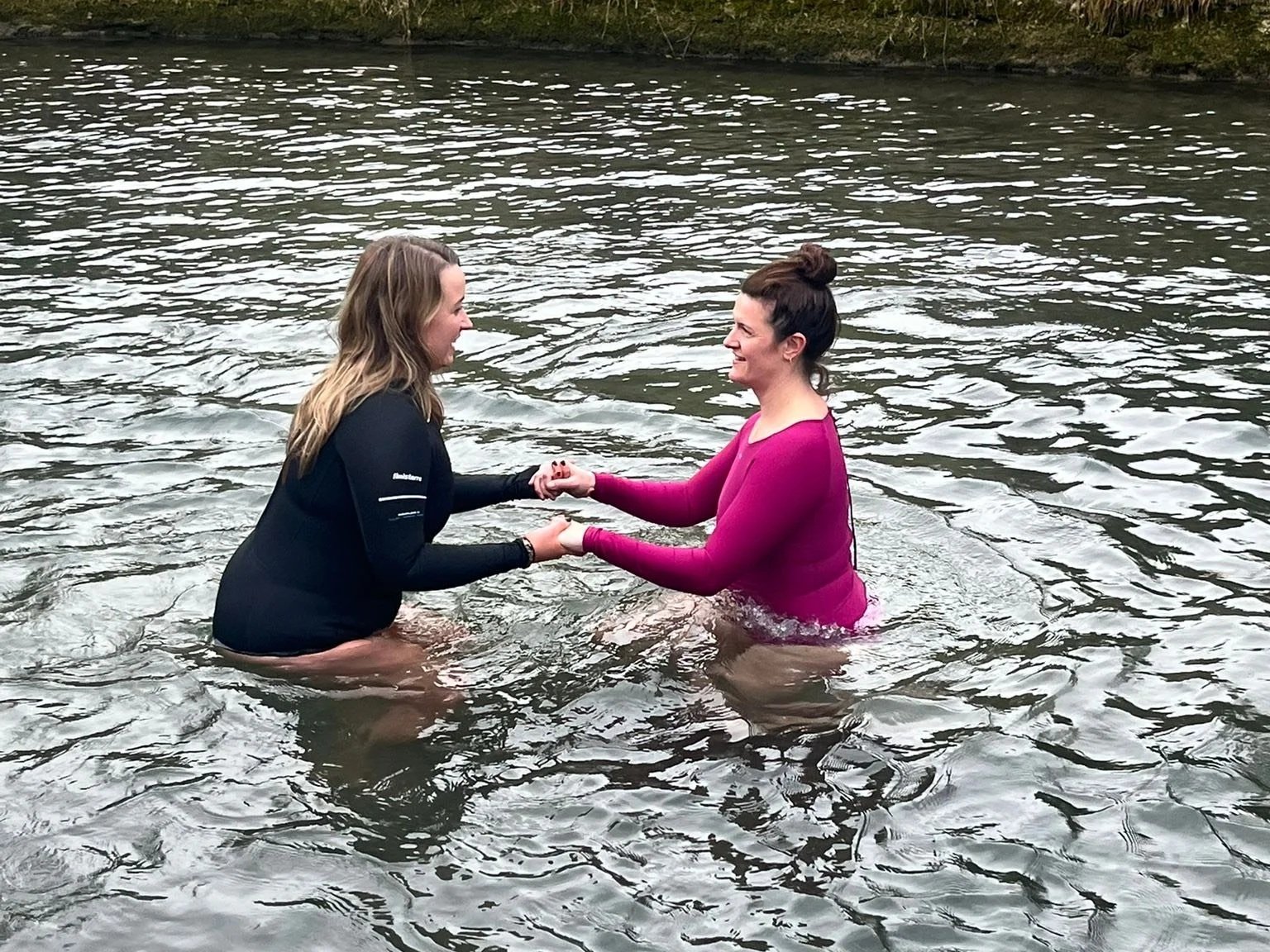 Two women doing a lake dip on a Satya Sanctuary retreat in the peak district