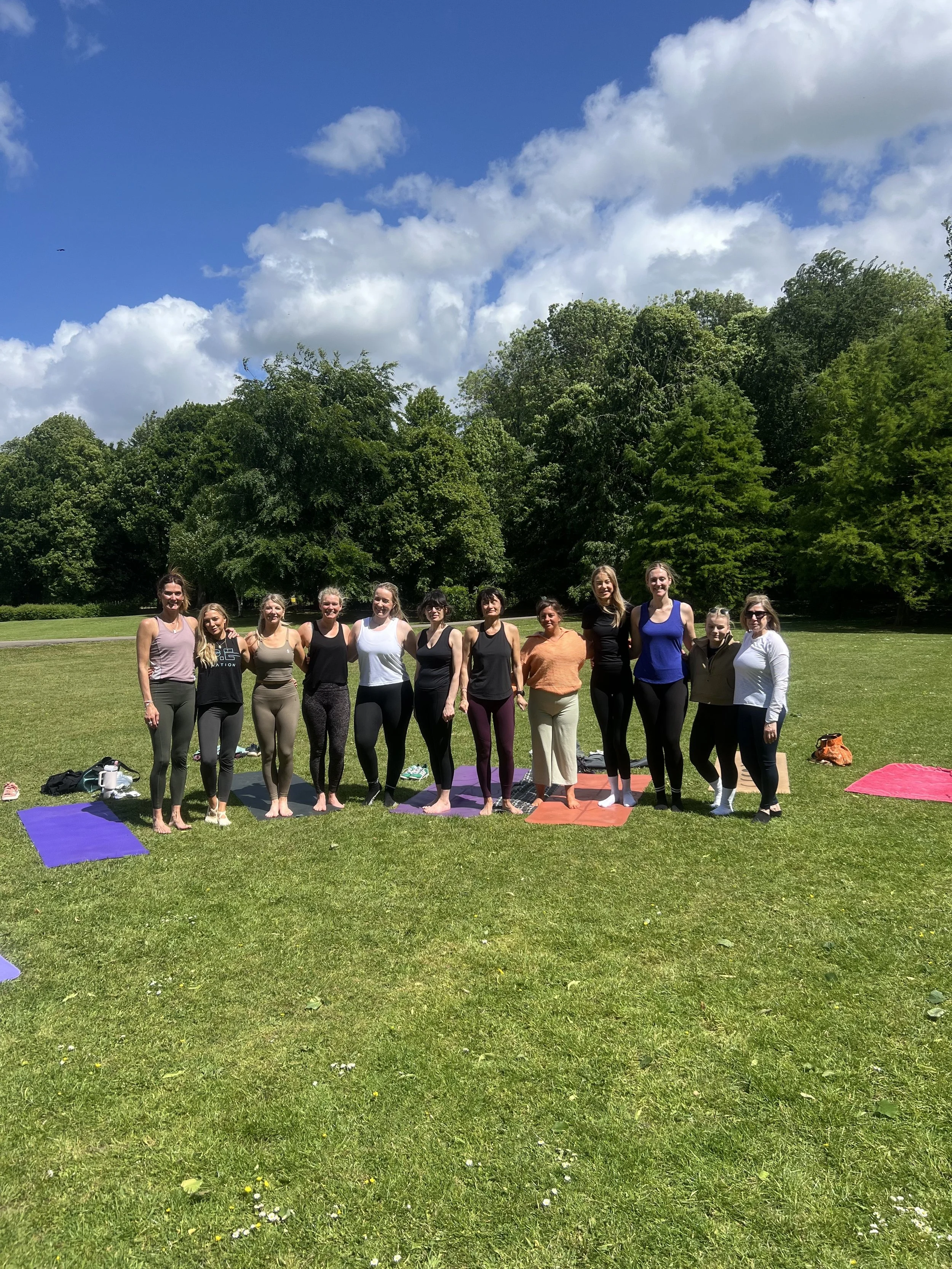 Group of women from Satya Sanctuary doing Yoga in the park