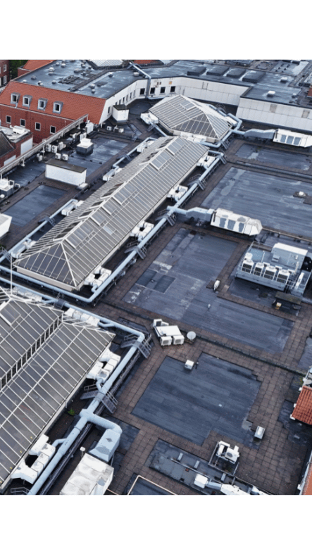 Commercial flat roof with skylights, HVAC and solar panels captured by drone for Ovrsite roof condition reporting.
