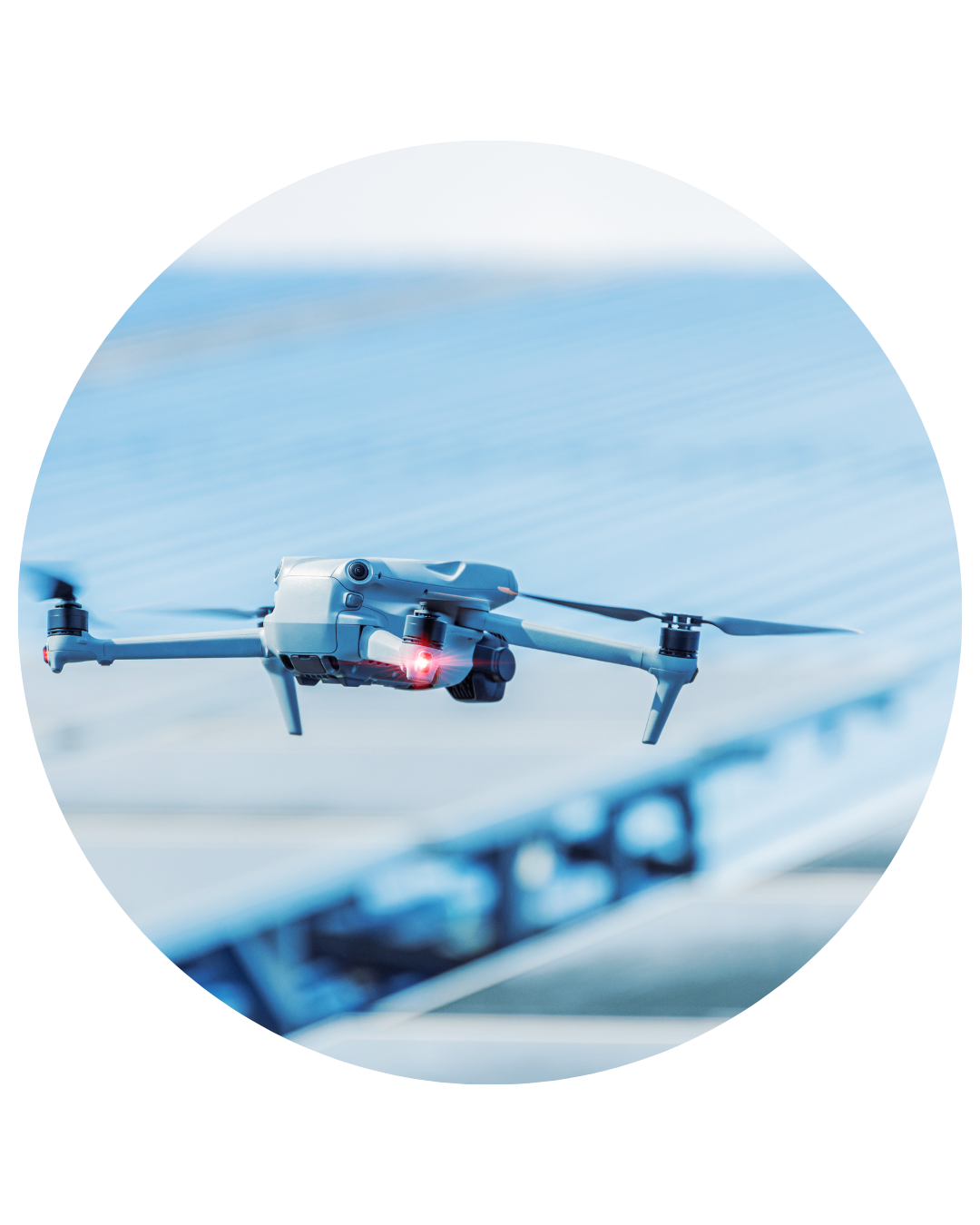 Ovrsite drone flying above commercial building that has PV and solar panels