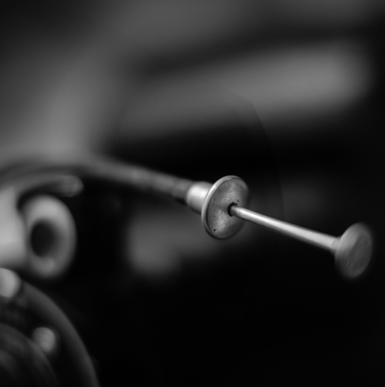 Macro and shallow depth of field view of an old-style camera shutter release
