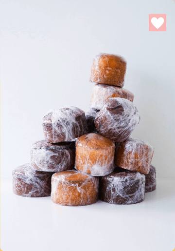 Stack of ice cubes on a white surface with a plain white background.