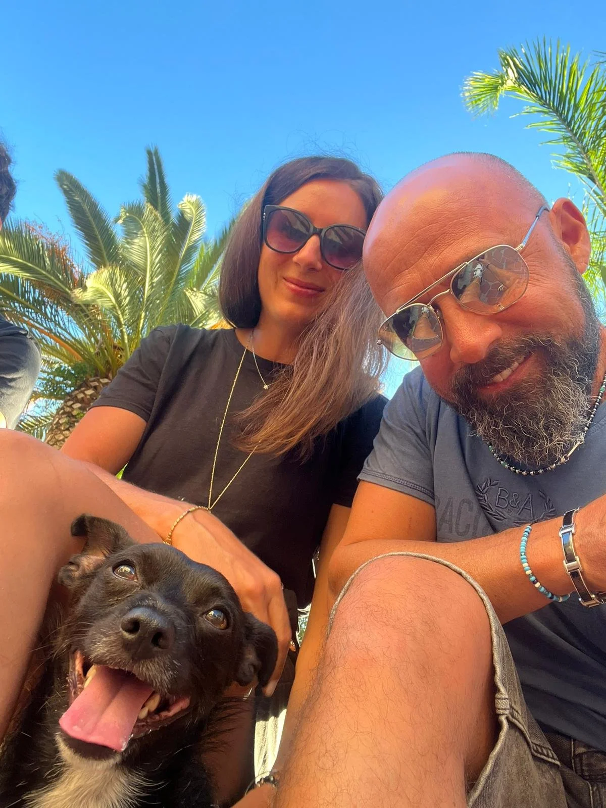 Alice, Andrea e Ragù di Mission Ragù con un bel cielo blu e palme.