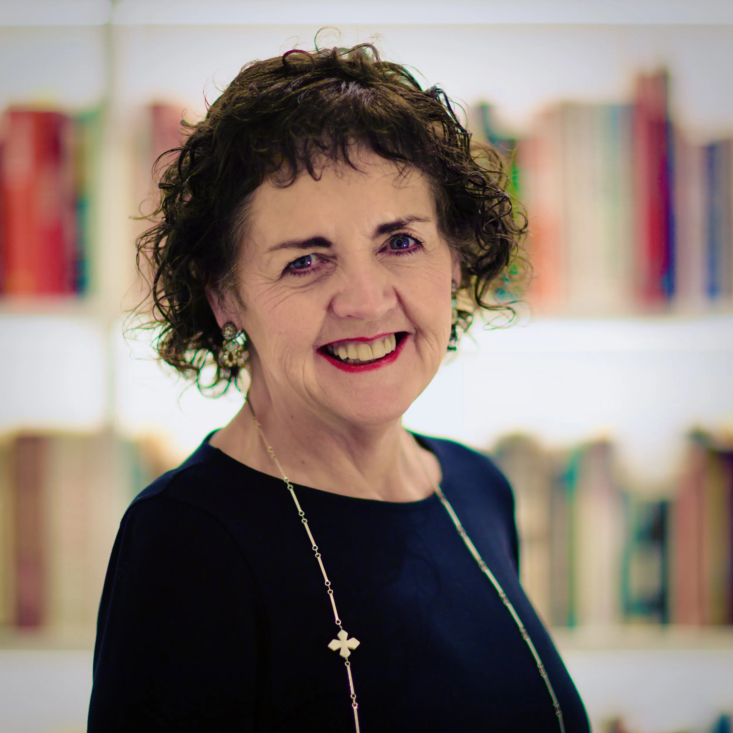 Jane Haberlin standing in front of a bookshelf.