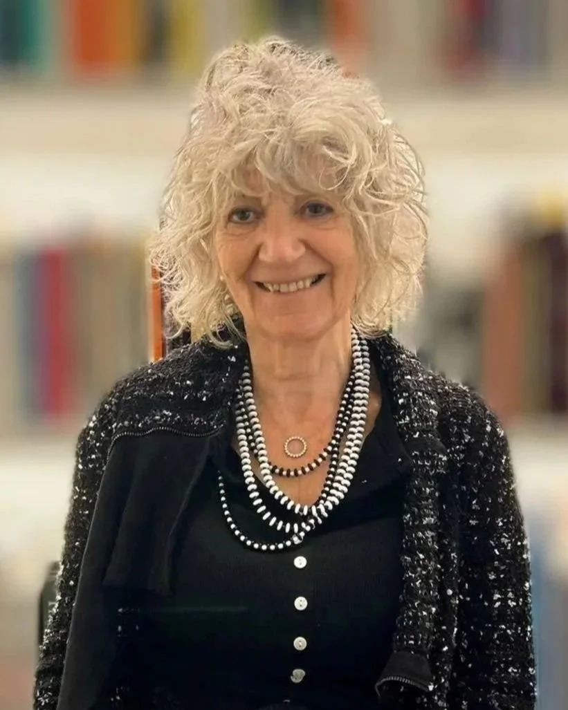 Dr Susie Orbach standing in front of a bookshelf.