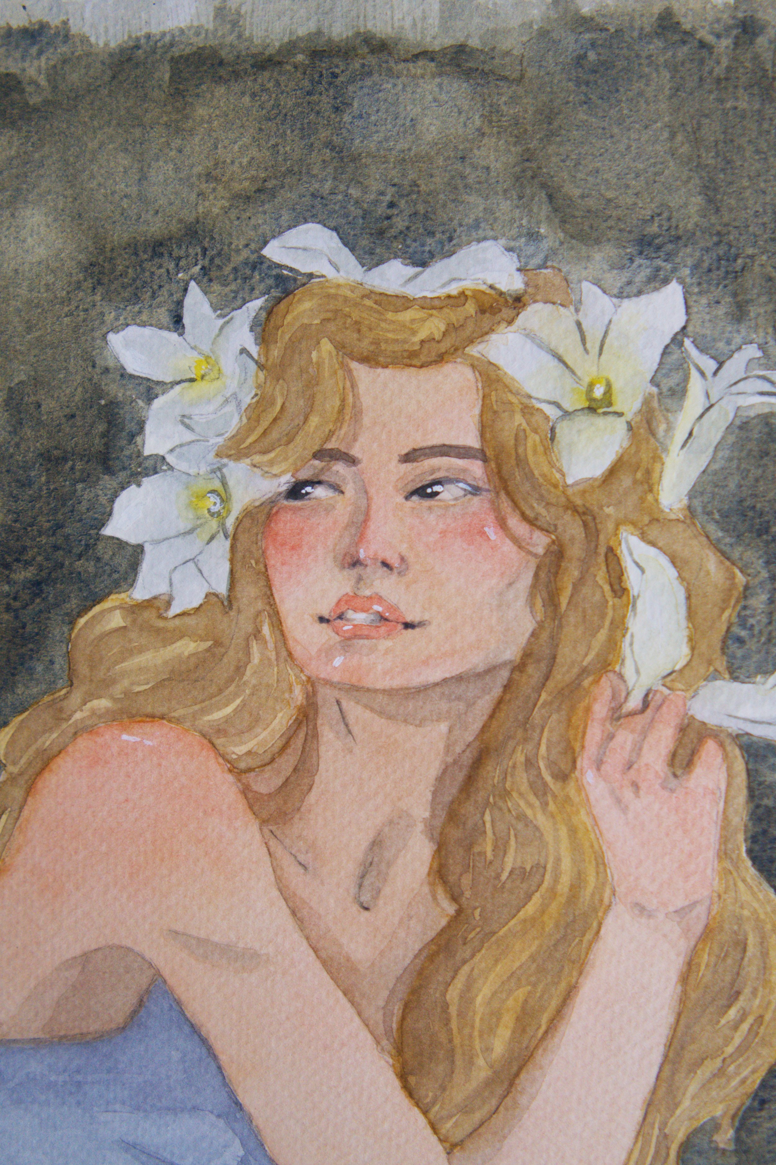 A watercolor painting of a woman with long, wavy blonde hair, wearing a crown of white flowers, and a soft expression on her face. She is holding a flower near her face, with a gray textured background.