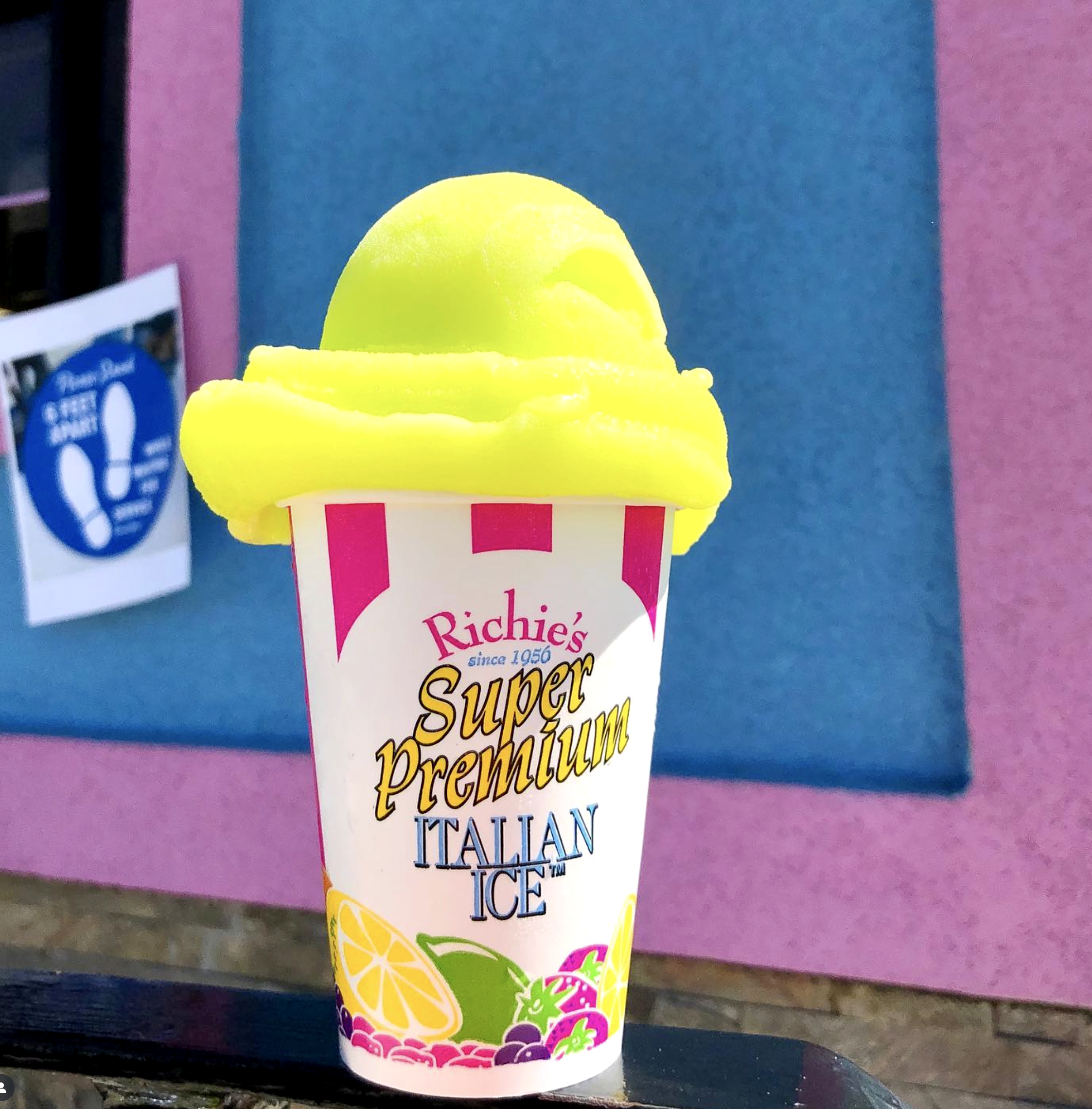 Colorful ice cream cup with lemon, raspberry, orange, grape, and pineapple flavors, labeled 'Richie's Summer Super Premium Ice'.