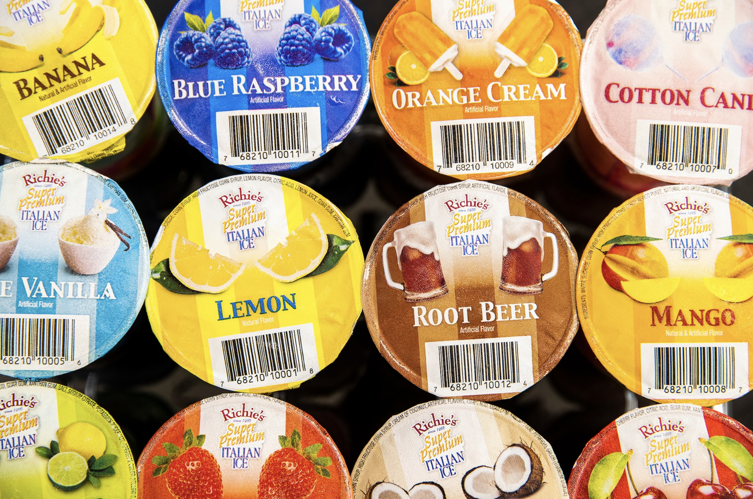 Assorted flavors of Richie's Italian ice, including banana, blueberry raspberry, orange cream, cotton candy, lemon, root beer, mango, strawberry, coconut, and more