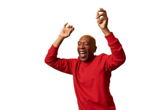 Man in a red sweatshirt dancing and smiling with eyes closed.