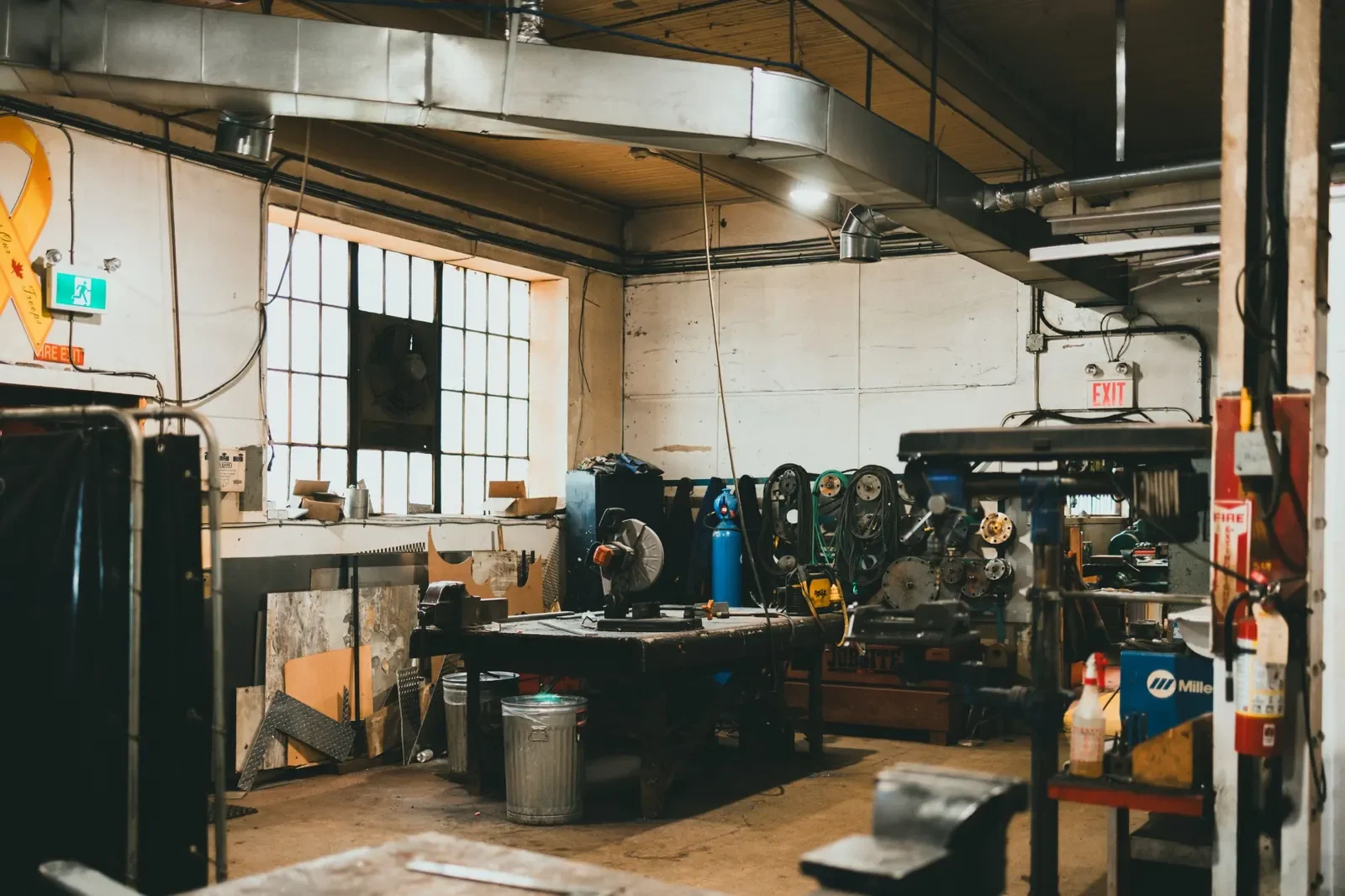 Industrial workshop interior with fabrication equipment and worktables
