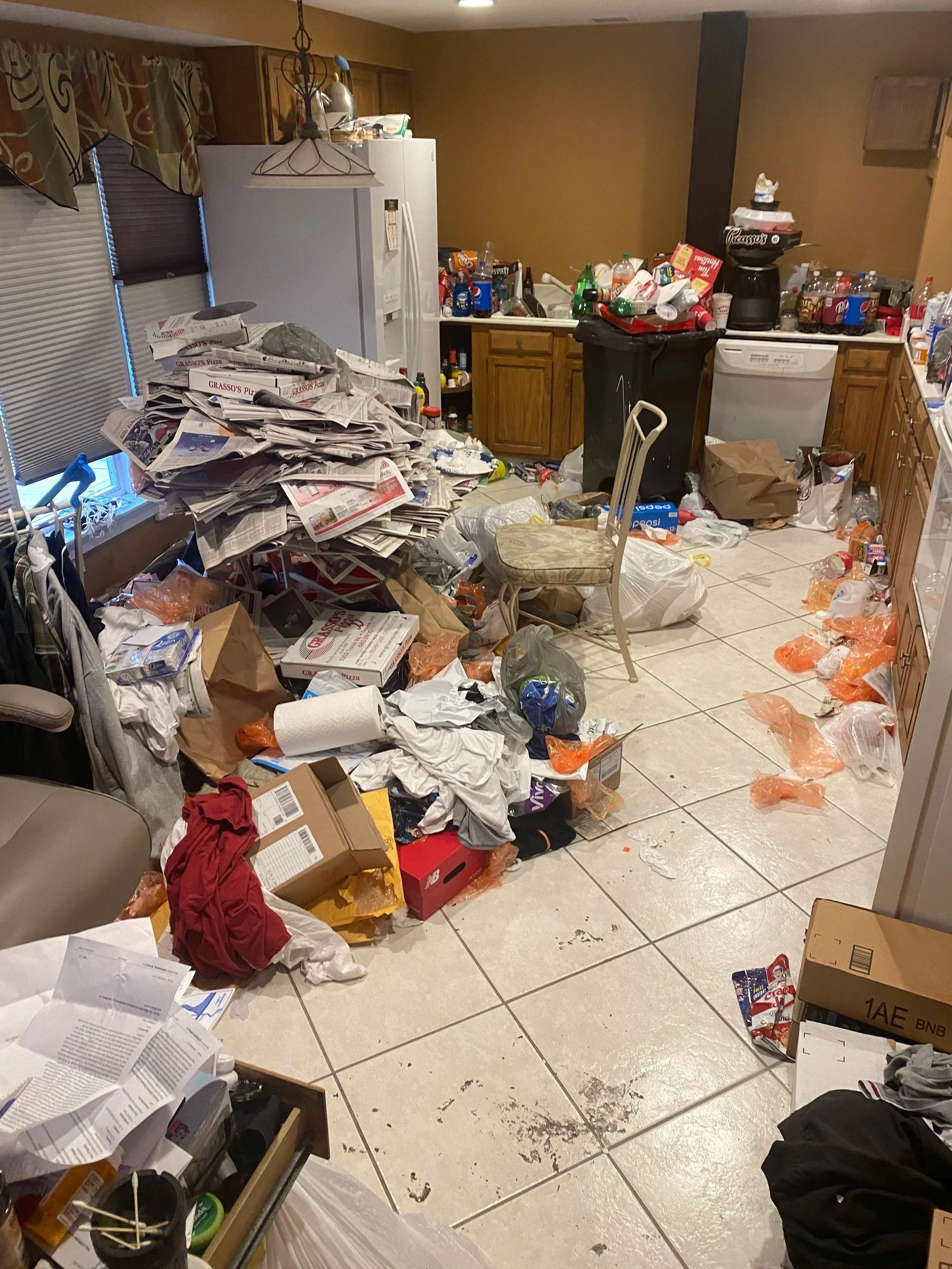 "Dirty kitchen in Buffalo, NY before professional deep cleaning with cluttered counters, grease, and stained surfaces."