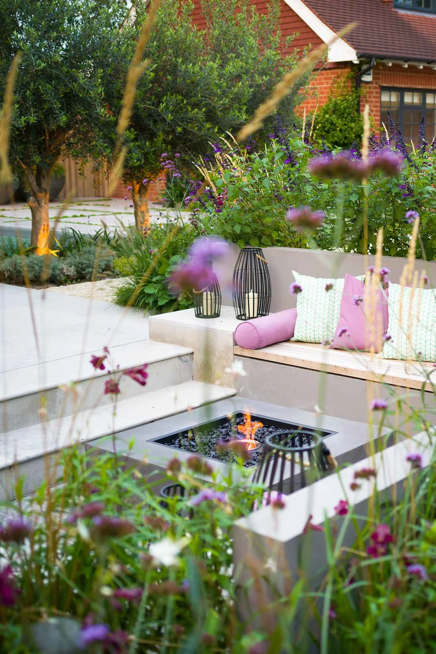 Elevated seating area overlooking a garden with built-in benches and planting