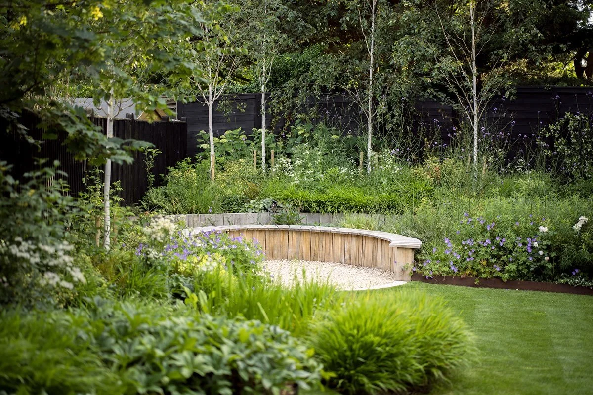 A corner of a garden in Surrey completed last year.  An awkward shaped and sloping garden and this is the very far corner that was seldom used. Now a spot surrounded by planting that coaxes you in to sit and ponder for a while.. 

Design&amp;Build: @