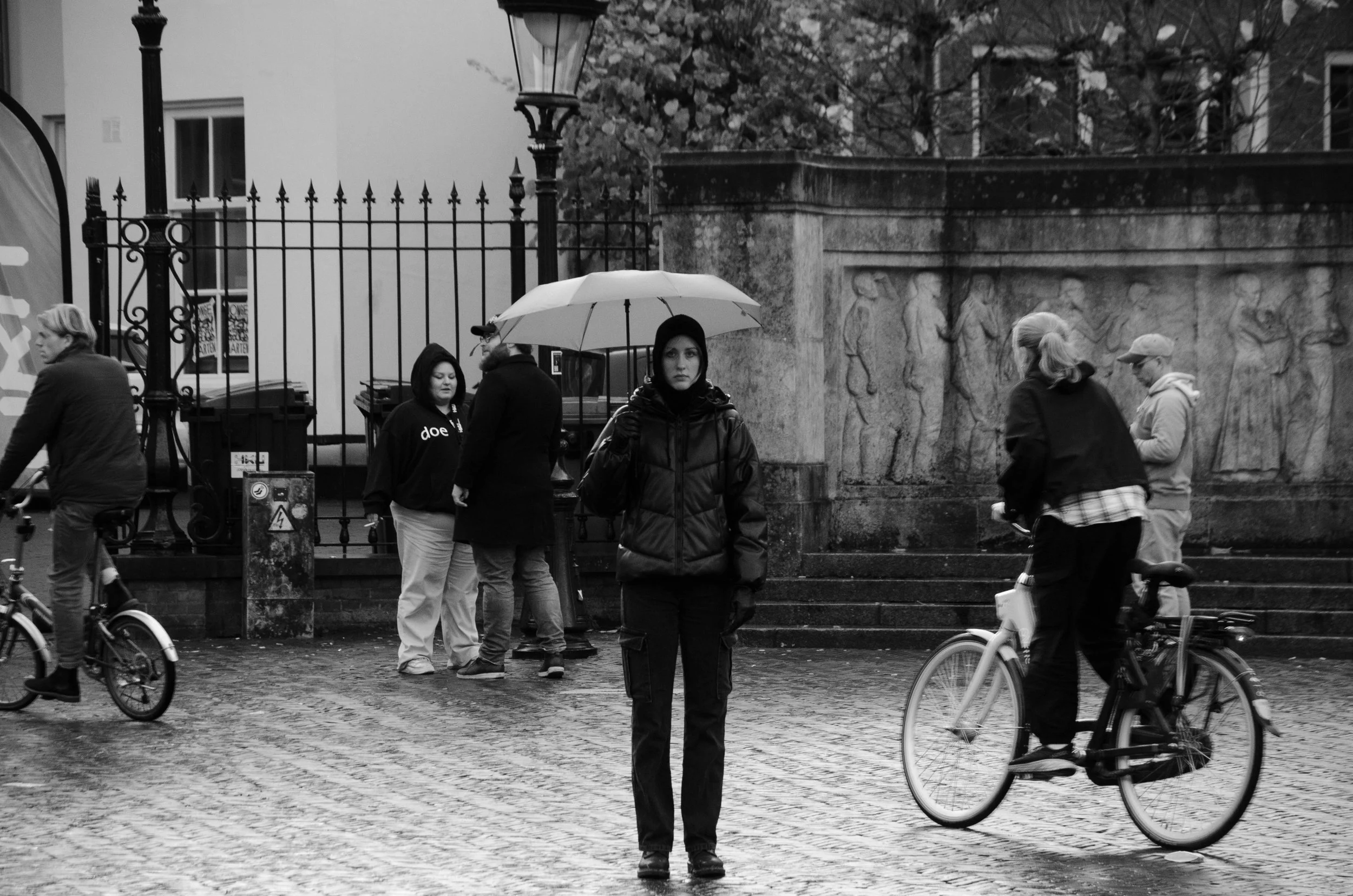 netherlands street photography, protection, umbrella, rain, bikes, motion, black and white