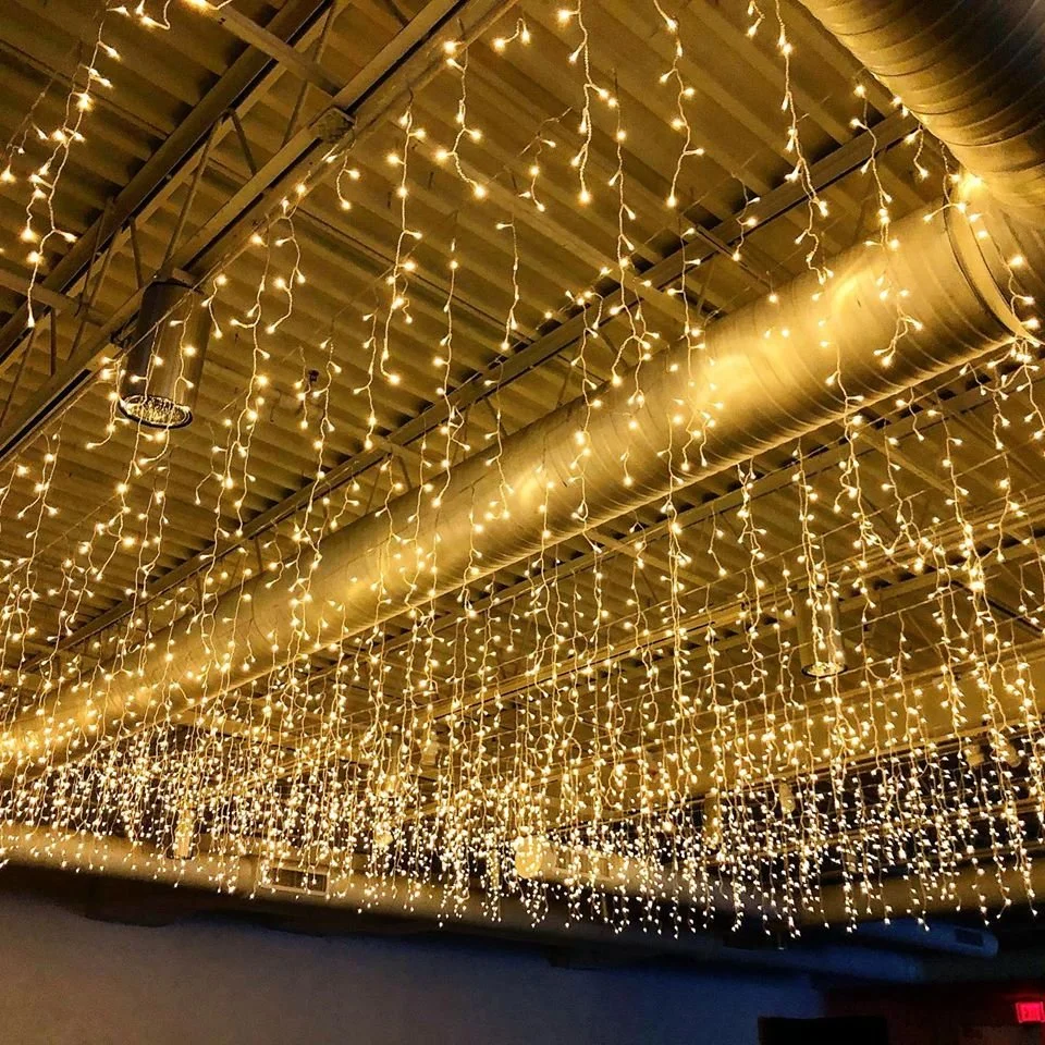 Ceiling decorated with hanging string lights creating a warm, festive atmosphere.