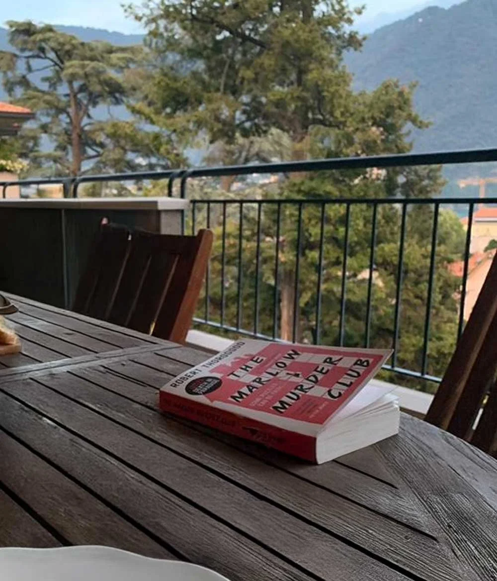 Book on a table with a mountain landscape in the back